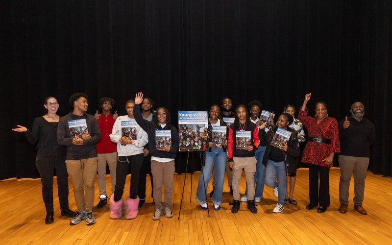 Students at a Young Voices book launch holding their books