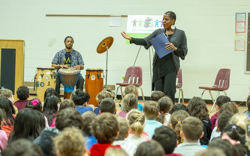 Caroline with elementary students during a school visit